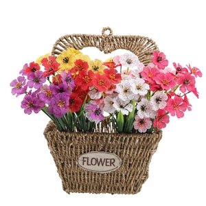 Detailed view of artificial violet bouquet in woven flower basket with handle and label