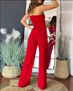 Detail shot of a red strapless wide-leg jumpsuit with decorative golden buttons