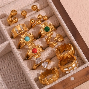 Collection of vintage 18K gold plated stainless steel rings with floral and gem accents