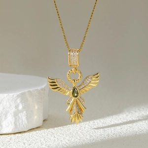 Exquisite gold phoenix wing necklace featuring a green teardrop gemstone and white zircons