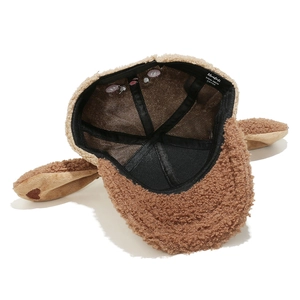 Close-up of brown plush bunny hat interior featuring Mushali brand label and soft lining