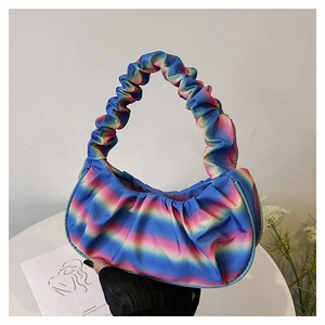 Detail of colorful rainbow gradient pleated handbag with soft cloud texture and handle