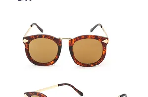 Detail of tortoise shell cat eye sunglasses with gold bridge and side arrow accents