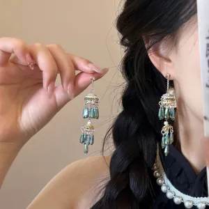 Detail of vintage silver fringe earrings with teal waterdrop beads and pearl accents