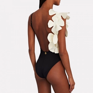 Women's V-neck one-piece swimsuit with 3D white floral decor and open back in black