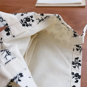 Detail view of cotton floral tote bag interior showing the inner pocket and fabric texture