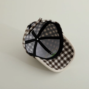 Detailed interior view of plaid wool baseball cap with sweatband and reinforced stitching