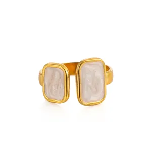 Detail of adjustable gold-plated stainless steel ring with white marble enamel inlay
