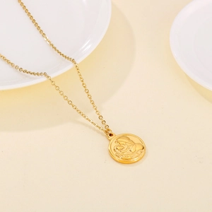 Detailed relief of mother and baby on golden pendant with classic O-chain necklace
