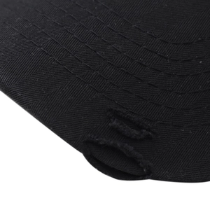 Close-up of distressed brim on black cotton baseball cap with parallel stitching details