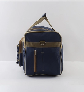 Detail showing deep blue waterproof travel bag with khaki webbing and metal D-ring attachment