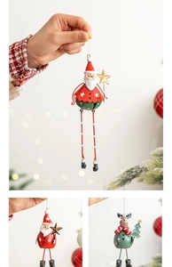 Detail of metal Christmas bell ornaments featuring Santa and reindeer designs