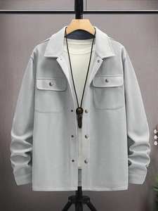 Detail of light grey corduroy shacket with chest flap pockets and metal buttons