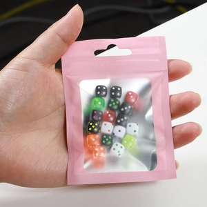 Colorful mixed dice beads in a pink matte window pouch for DIY jewelry making