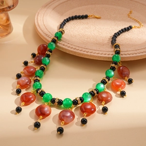 Detailed macro view of ethnic beaded necklace with colorful resin stones and gold accents