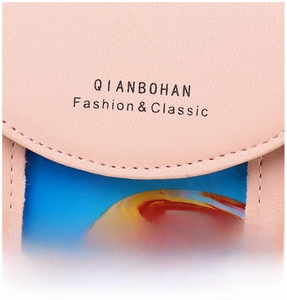 Close-up of pink pebbled leather texture with embossed brand logo and card slot detail