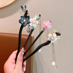 Handcrafted sandalwood hair sticks with floral tassels for traditional Chinese hairstyles
