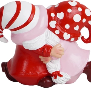 Close-up of hugging gnome couple figurine with red stripes and heart patterns
