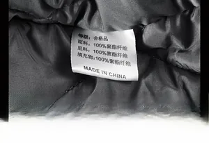 Macro shot of 100% polyester lining and wash care label on men's bomber jacket