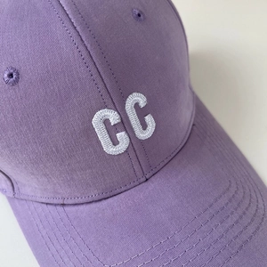 Detailed close-up of lavender cotton baseball cap with 3D white CC letter embroidery