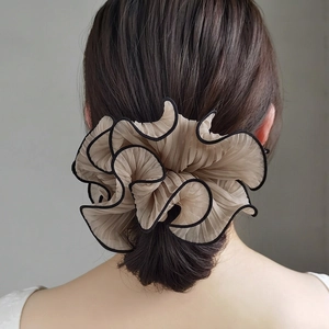 Elegant oversized pleated beige scrunchie with black ruffled edges for a stylish ponytail