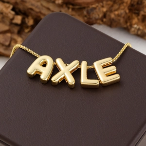 Gold bubble letter necklace with AXLE pendant, trendy minimalist design for women daily wear.