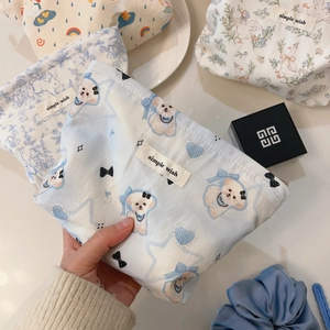 Detail of cartoon printed cotton cosmetic bags with cute animal patterns and woven labels