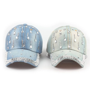 Close-up of denim baseball caps in dark and light blue with sparkling rhinestones