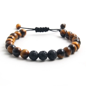 Detail of adjustable braided rope bracelet with 8mm tiger eye and volcanic stone beads