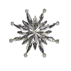 Elegant silver snowflake brooch with sparkling crystals on a clean white background