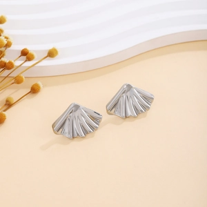 Detailed view of silver pleated fan-shaped metal stud earrings with textured surface