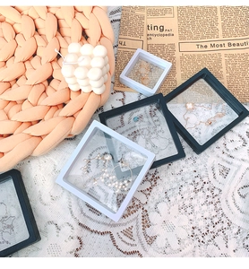 Detail view of PE film jewelry organizers showing rings and necklaces in floating storage