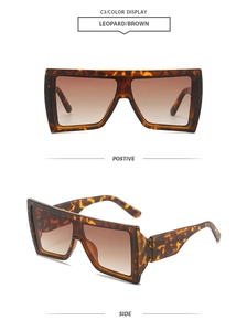 Detail view of leopard print oversized sunglasses with brown gradient lenses