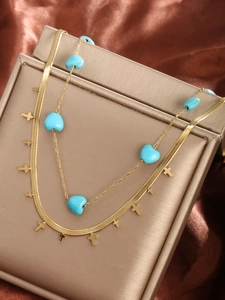 Detailed close-up of 14K gold plated double layer necklace with turquoise hearts and crosses