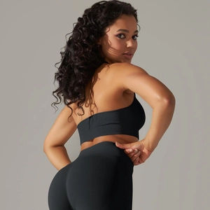 Detail of black ribbed seamless yoga set showing high-waist leggings and sports bra texture