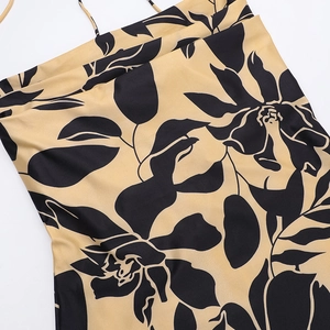 Close-up of khaki floral print dress showing smooth satin fabric and neckline detail
