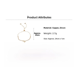 Detail of adjustable gold-plated bracelet with zircon bow and heart charms on white base