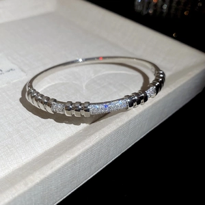 Macro detail of silver finish 18K gold plated zircon rivet buckle bracelet on a jewelry box