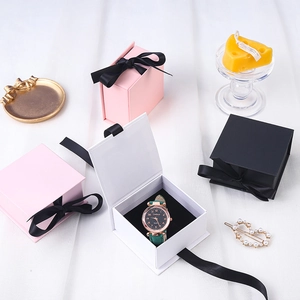 Elegant jewelry gift boxes with ribbons in pink, black and white for watches and rings