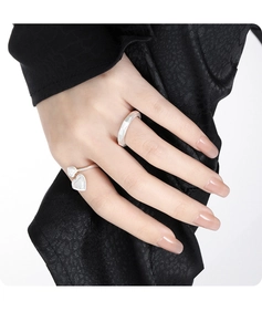 Detail of S925 sterling silver rings with geometric cut and double heart on silk