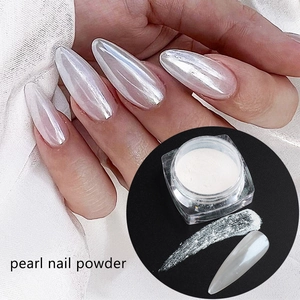 Detailed view of pearl nail powder application on long nails with macro texture
