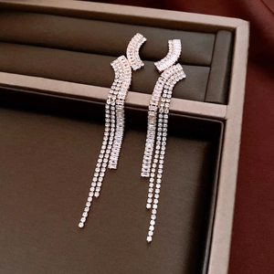 Macro shot of rose gold tassel earrings with multi-row zircon fringe in a jewelry box