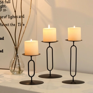 Set of three matte black metal Nordic candle holders in small, medium, and large sizes