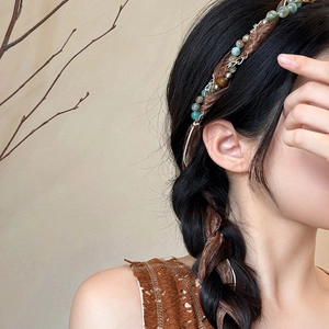 Bohemian braided hair tie with colorful natural stone beads shown on a brunette braid
