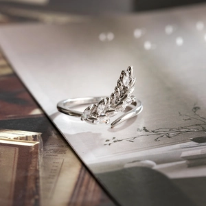Detailed view of silver olive leaf open ring with zircon inlay on magazine page