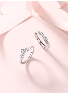 Detailed close-up of S925 sterling silver couple rings with crown design and zircon stones