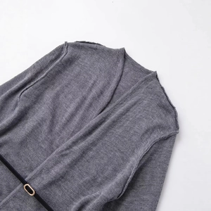 Grey wool blend knit cardigan featuring a V-neck design and a black leather waist belt