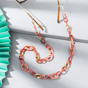 Detail of pink and gold chunky acrylic eyeglass chain with transparent rubber loops