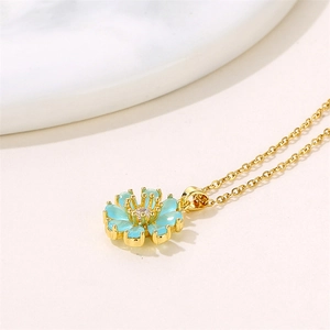 Golden necklace with a light blue sunflower pendant and central zircon accent
