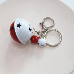 Close-up of a red and white star-cut bell keychain with colorful mini bells on metal ring